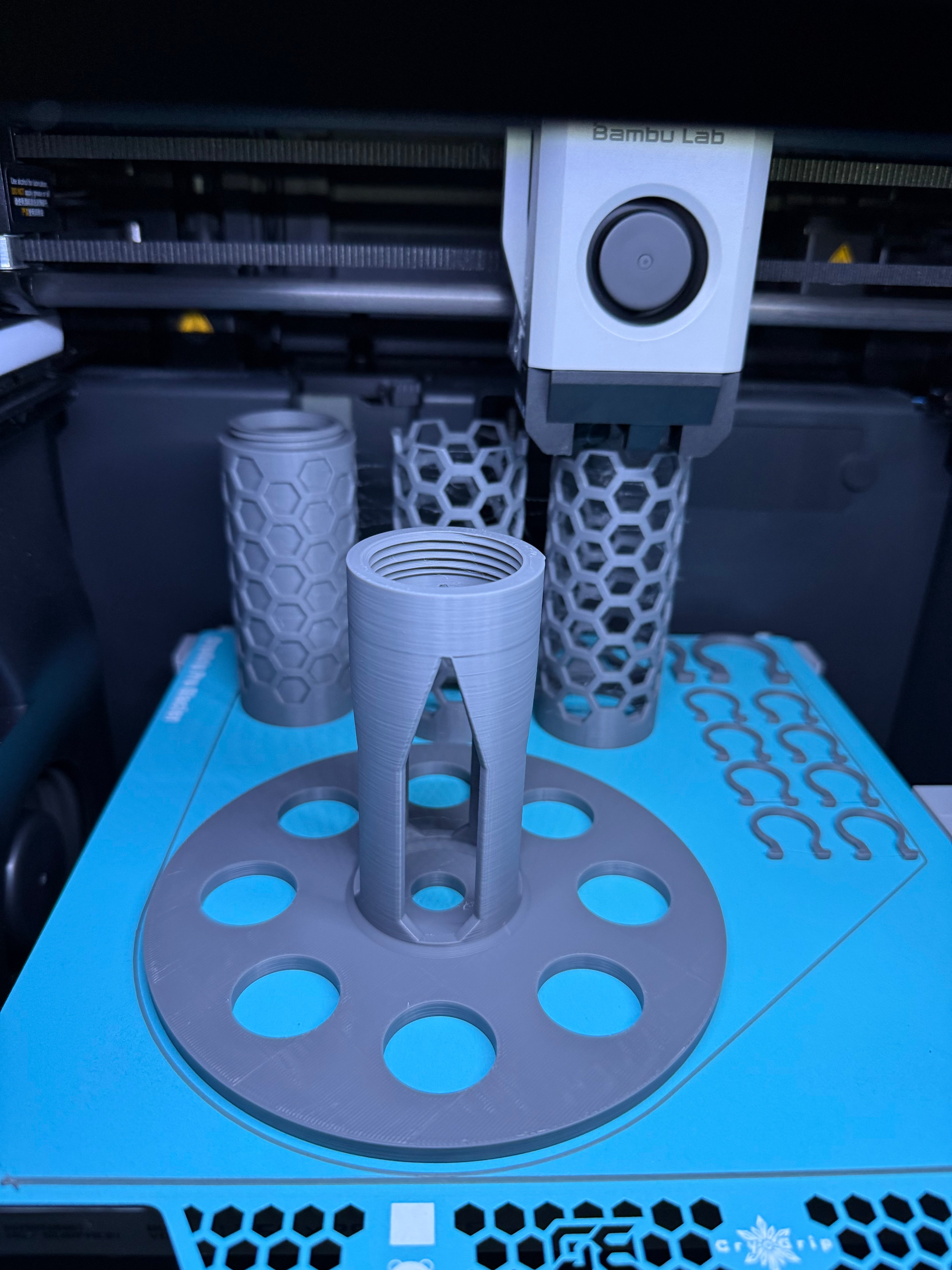 3D printed Modular Moss Pole Kit water reservoir, clips, and pole close up on printer bed