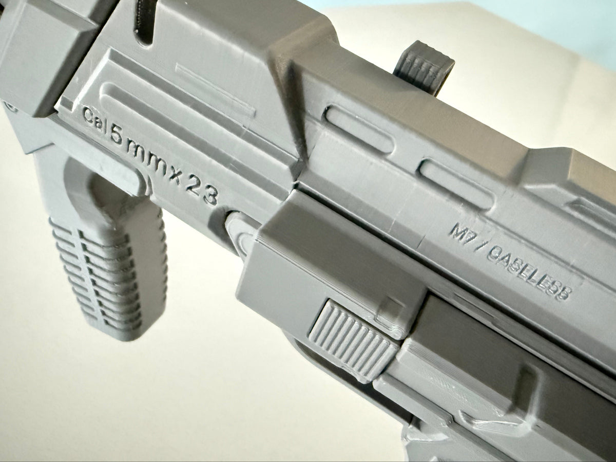 Close-up of the M7 Caseless SMG's top rail engravings, Cal 5mmx23 and M7/CASELESS