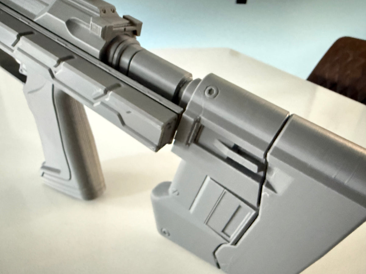 Close-up of the M7 Caseless SMG prop's folding stock hinge mechanism