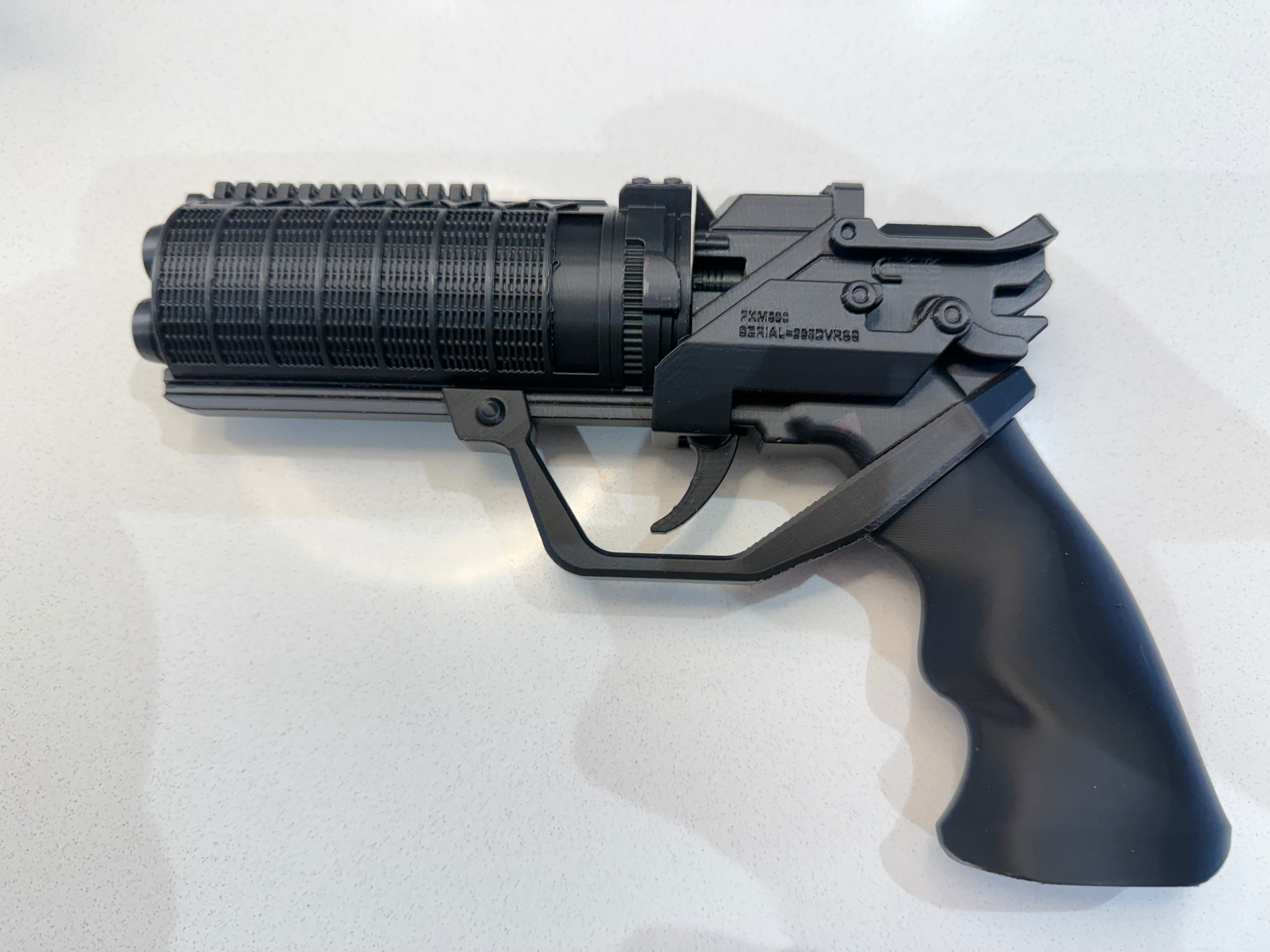 Fully assembled 3D printed K's Blaster cosplay prop kit in black PLA, side profile