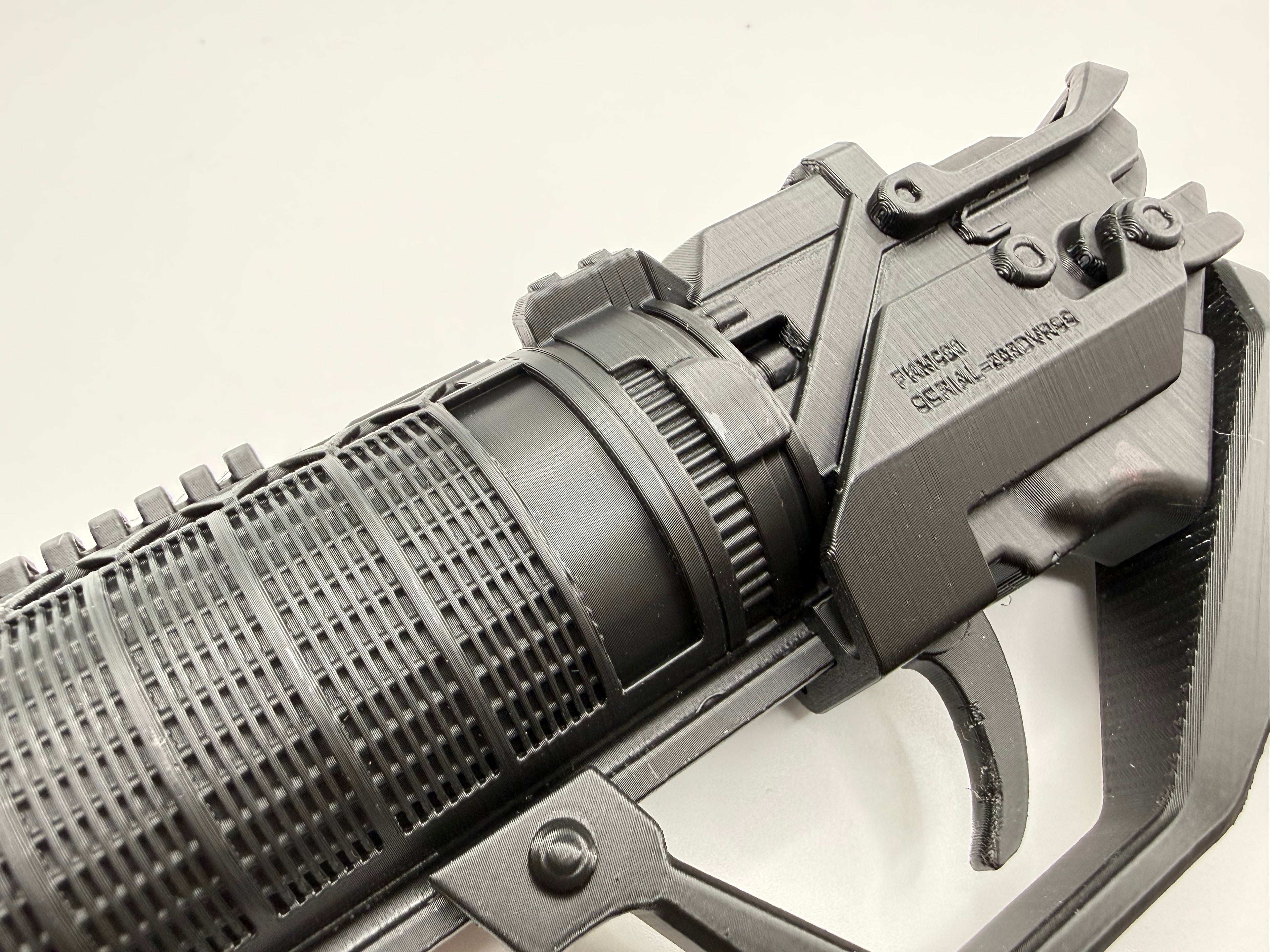Close-up of the K's Blaster barrel shroud joining the receiver, with engraved serial plate detail