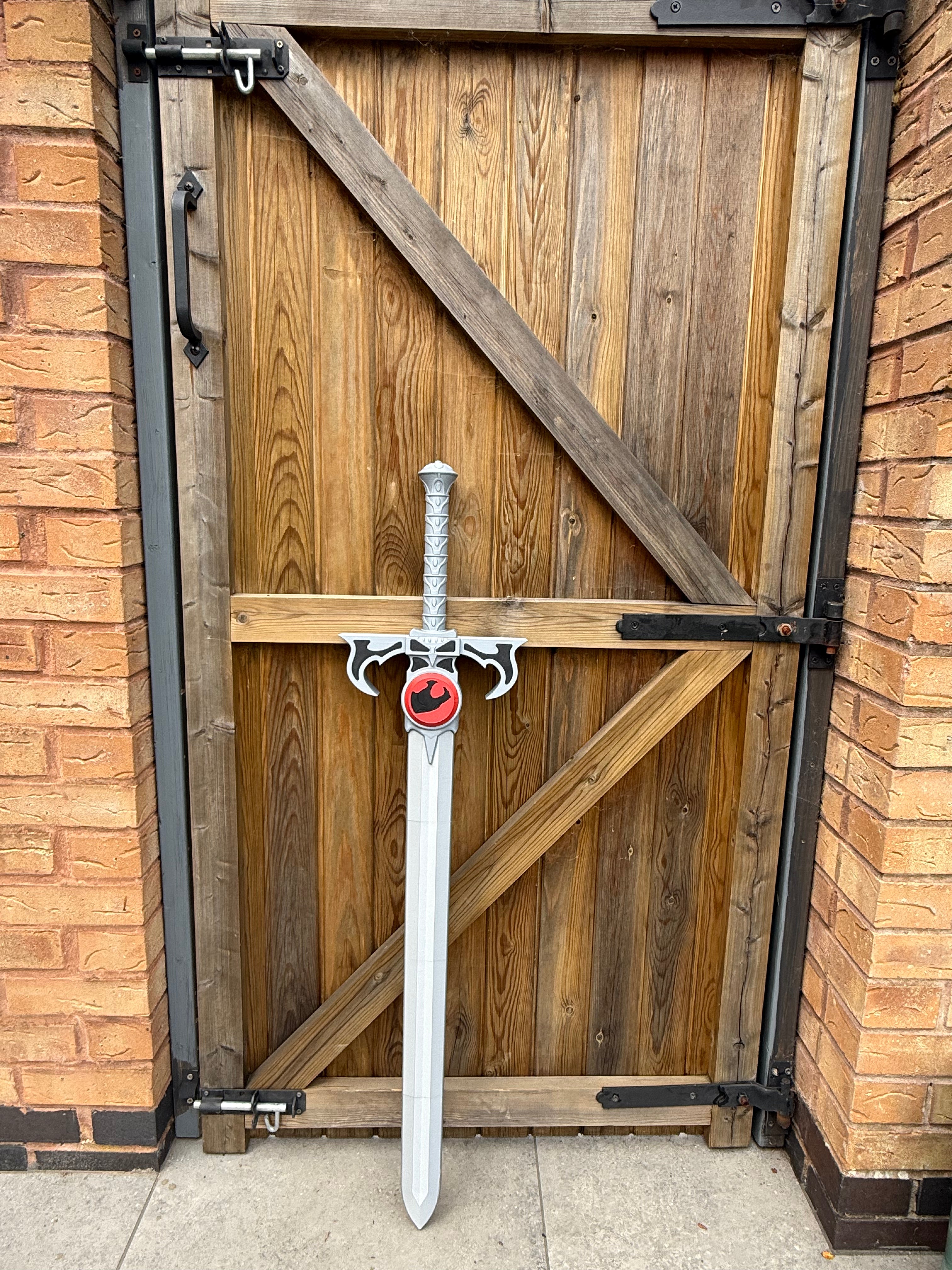 Sword of Omen lent against Gate