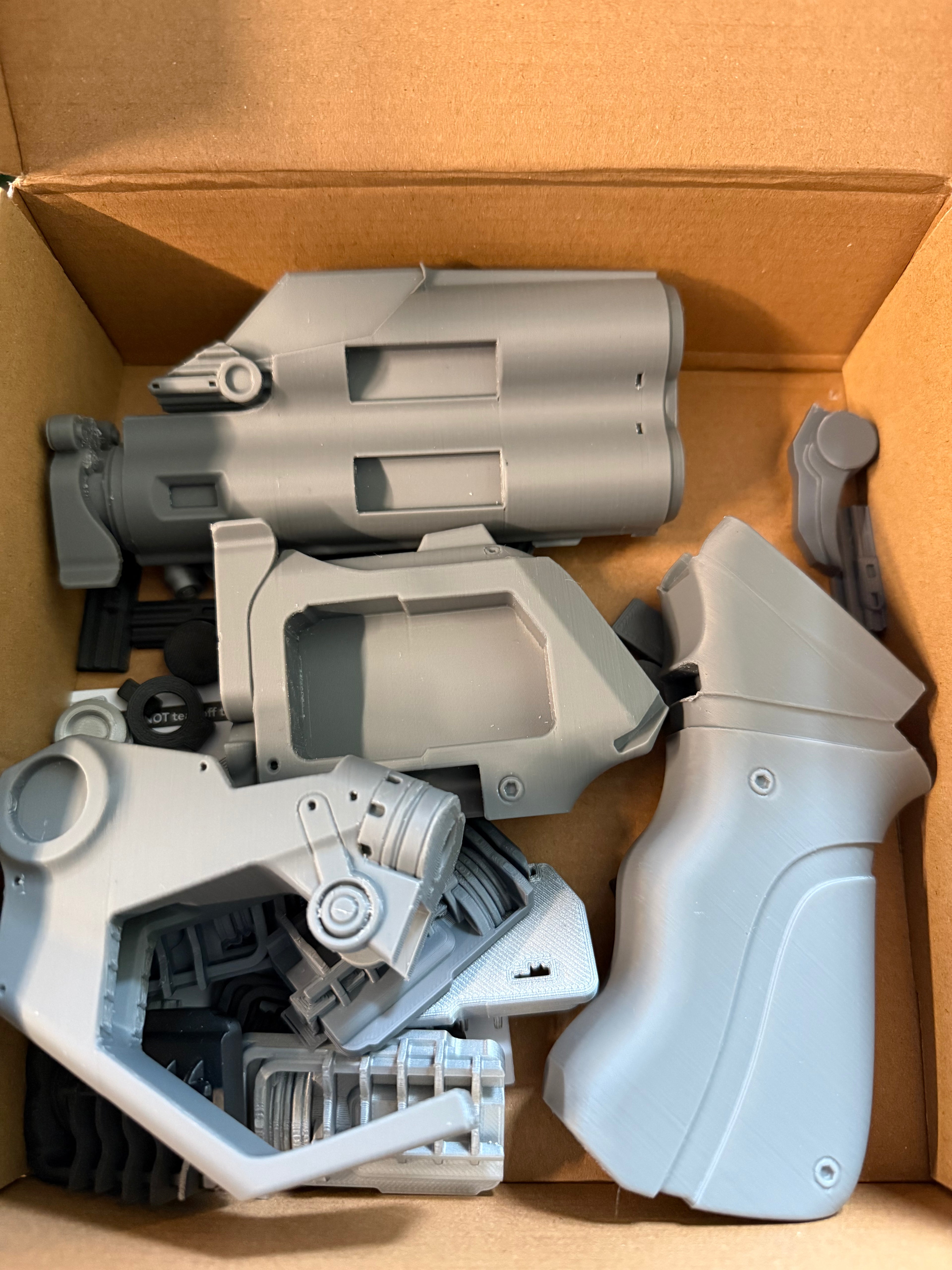 Model Parts Luv Blade Runner Gray plastic gun components in a cardboard box 3Dcre8Design