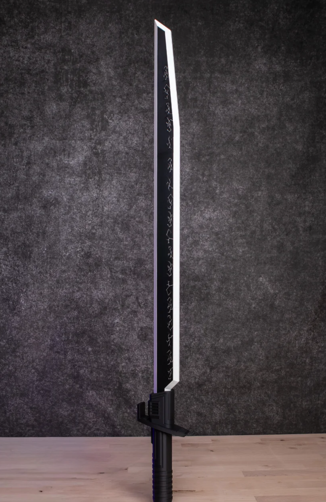 Sword with a black handle and silver blade against a dark gray background