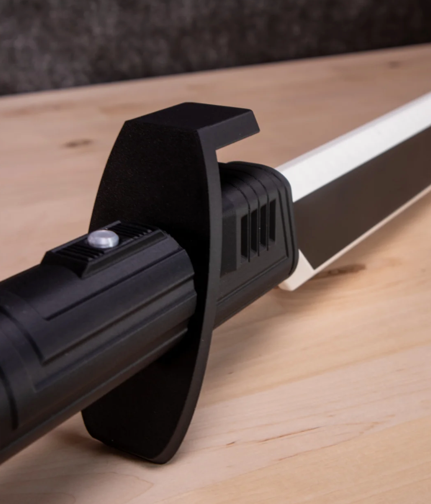 Black and silver vacuum cleaner head on a wooden surface