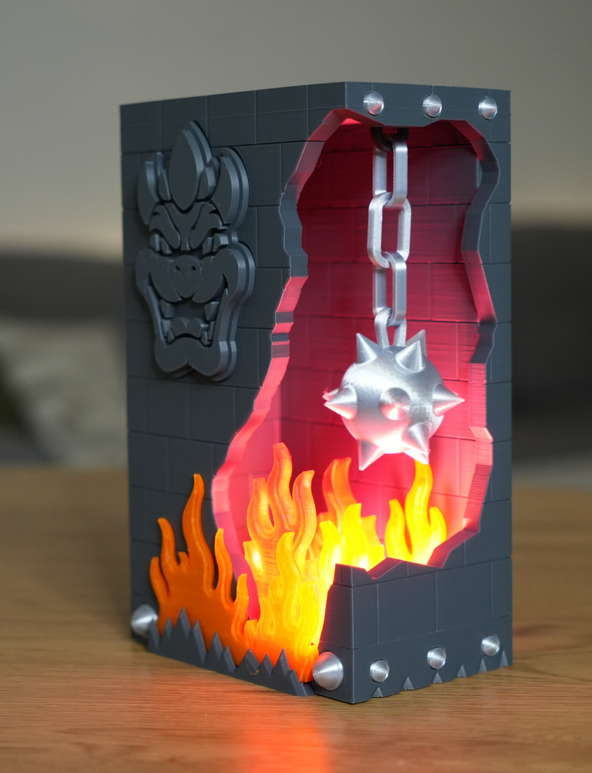 Broken Brick Bowser LED night light, lit version glowing red and orange from inside the broken brick, close-up angled view