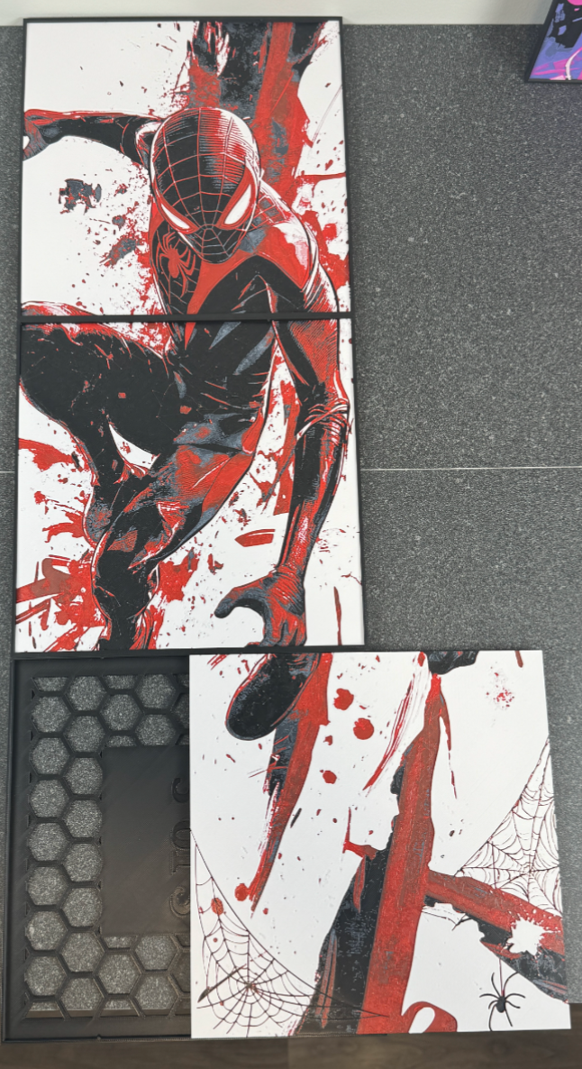 Spider-Man themed hueforge with red, black, and white design on a gray surface.