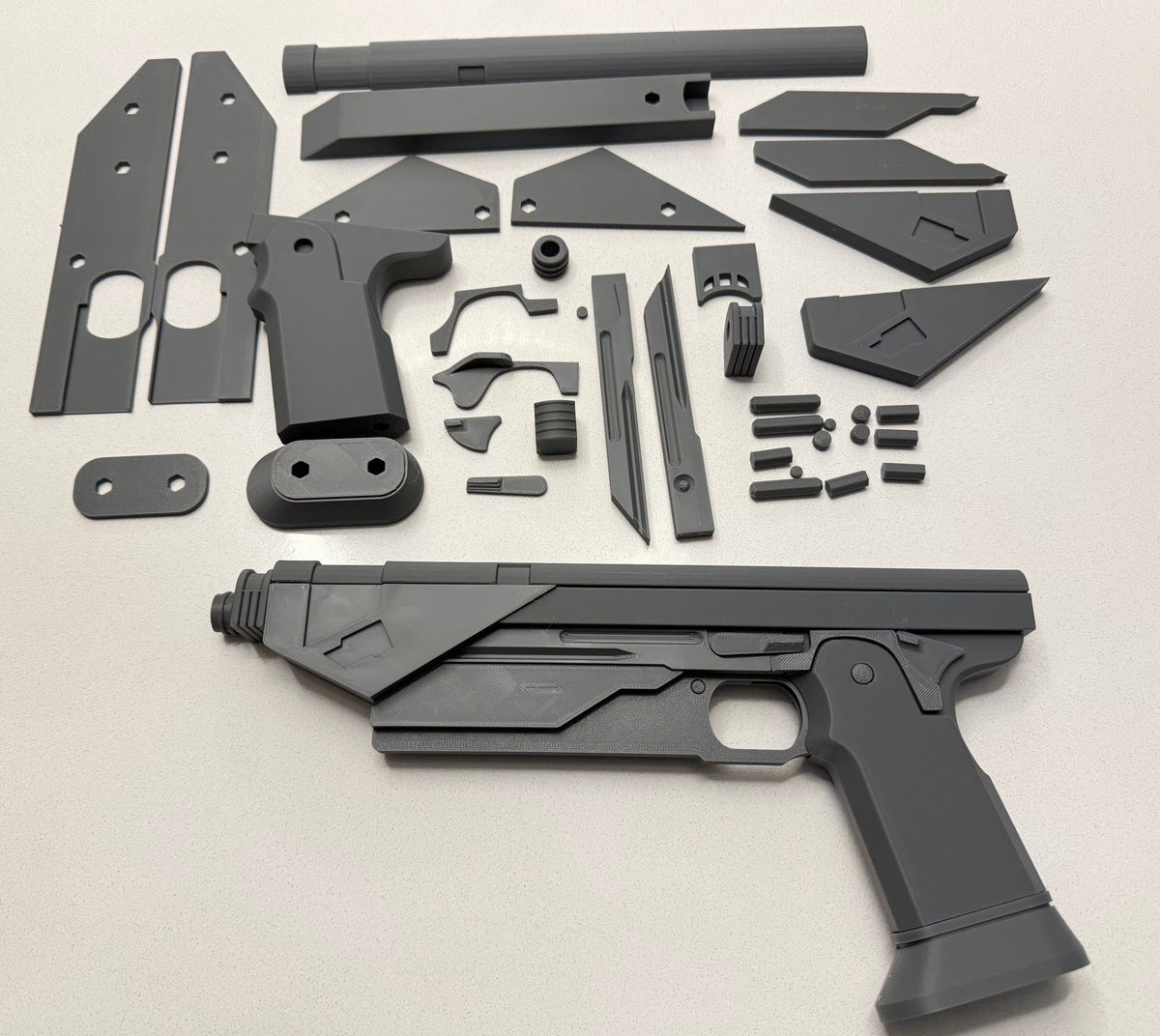 Westar-35 Blaster Pair 3D printed cosplay prop kit, full set of unassembled parts next to a built blaster